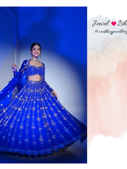 A vision in blue. This full-length shot shows how our statement Polki necklace and matching maang tikka create a breathtaking look when paired with a vibrant blue lehenga. Perfect for a sangeet or reception.