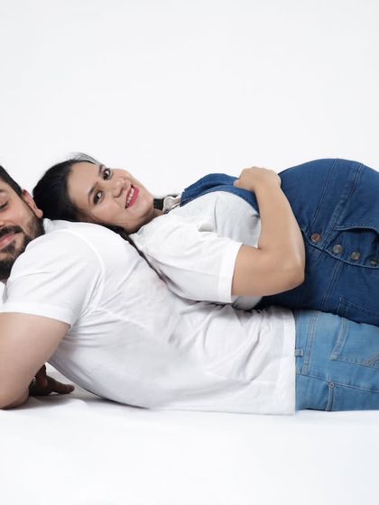A unique and playful pose with the expecting mother lying on her partner's back. We always try to find creative ways to make your photoshoot fun and memorable.
