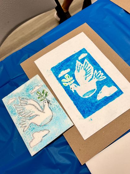 A beautiful dove of peace print created during our "Introduction to Printmaking" workshop. The image shows the foam plate used for carving and the final print.