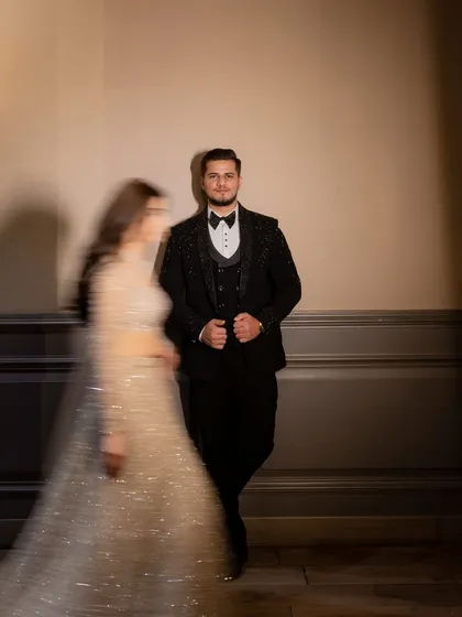 A creative engagement portrait using motion blur to create a dynamic and artistic image, with the groom in sharp focus as his bride moves past.
