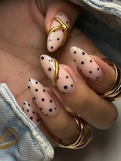 Another view of the stylish polka dot and gold accent manicure, showcasing the creativity and precision of our nail artists.