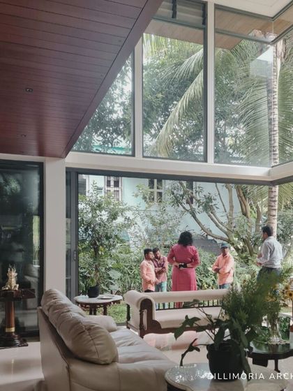 A real-life shot of our project, where floor-to-ceiling windows connect the living room directly with the lush garden. This design choice was central to our goal of creating a home that feels integrated with nature.