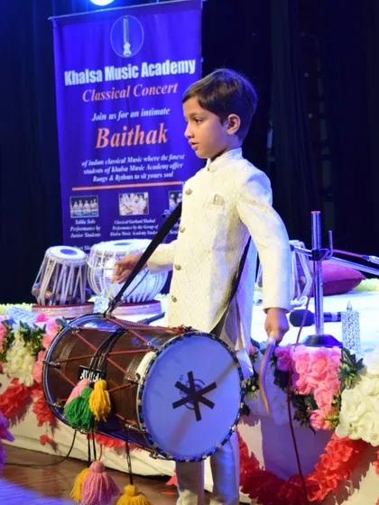 One of our youngest performers, Aviraj Singh, confidently takes the stage with a dhol. We welcome students of all ages, nurturing talent from the very beginning and providing them with opportunities to perform.