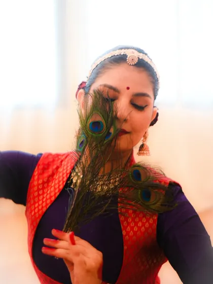 Exploring the art of 'Abhinaya' or expression. This portrait, themed around Lord Krishna, uses the iconic peacock feather to evoke a sense of devotion and storytelling, which is central to my performance philosophy.