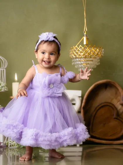Taking her first steps in a princess dress. This milestone moment was beautifully captured during her one-year pre-birthday shoot.