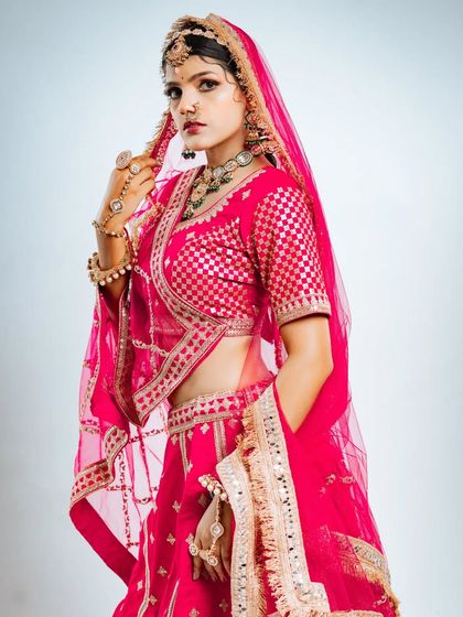 This shot captures the delicate net dupatta with its embroidered border, a key element of the bridal ensemble.