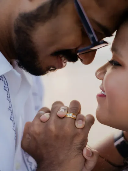 A close-up shot focusing on the couple's hands and the engagement ring, a beautiful way to highlight this symbol of their commitment.
