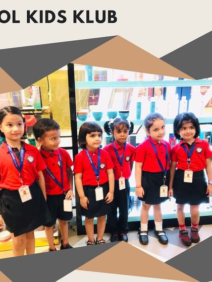 The "Kool Kids Klub" posing in front of our product display, showing off their neat school uniforms and happy faces.