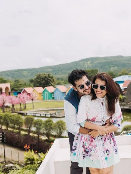 A happy, relaxed photo overlooking the entire studio set. This shot shows the variety of backdrops available, from colorful huts to lush greenery.