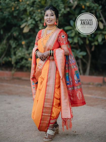 A full-length view of Akshaya in her stunning orange Paithani Nauvari saree, expertly draped by my artist Anjali to create a timeless and elegant silhouette.