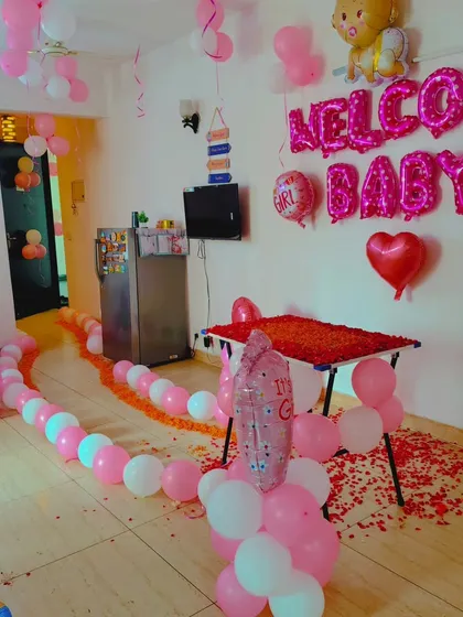 A closer look at the "Welcome Baby" home decoration, showing the path of balloons and flower petals.