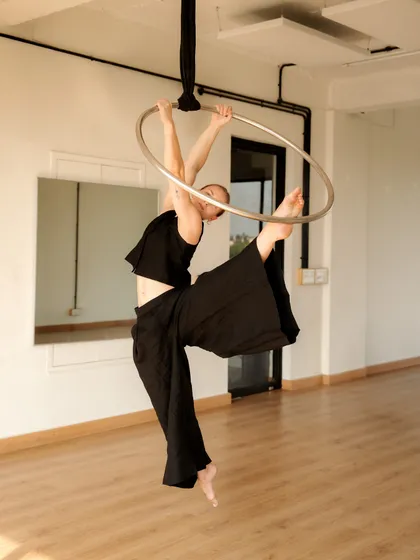 A flexible pose within the hoop, showcasing a side split. This highlights the flexibility training that is an integral part of my aerial arts classes.