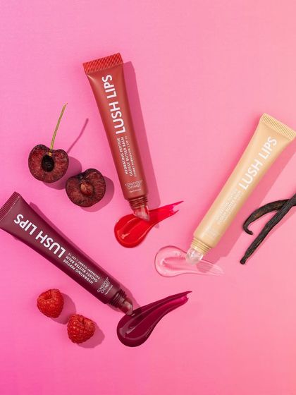 A vibrant flatlay that tells a flavor story. We arranged the lip glosses with their corresponding ingredients, cherries, vanilla, and raspberries, and added texture swatches on a bright pink background for a playful, delicious look.