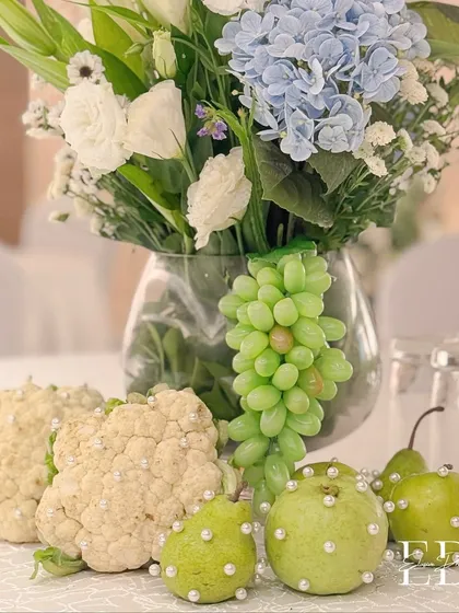 A detailed shot of the pearl-studded apples and guavas, showcasing the meticulous and creative detail that goes into each centerpiece.