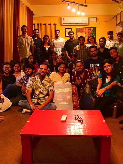 A group photo of all the performers and audience members after a wholesome and organic "Rhyme and Rhythm" night.