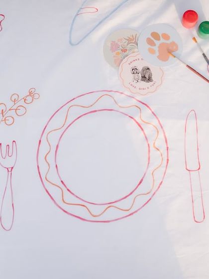 A detail of the custom-illustrated table runner, showing drawings of food and cutlery.
