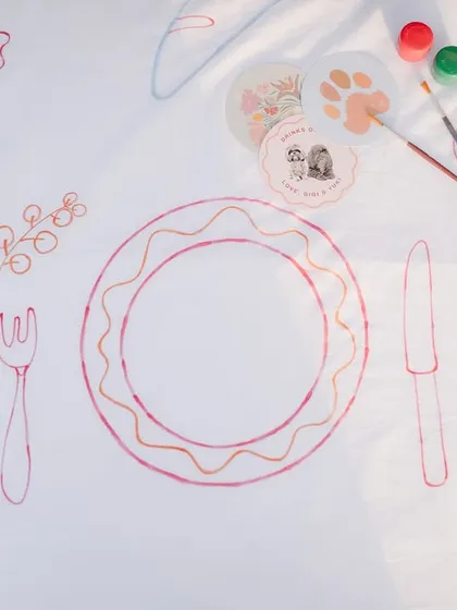 A detail of the custom-illustrated table runner, showing drawings of food and cutlery.