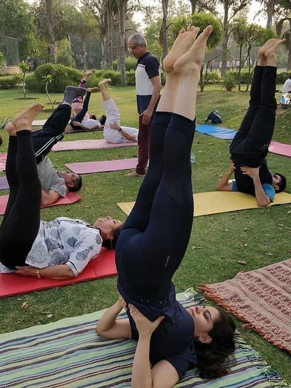 Students practicing Sarvangasana (Shoulder Stand), an important inversion for improving circulation. I guide everyone safely into and out of the pose.