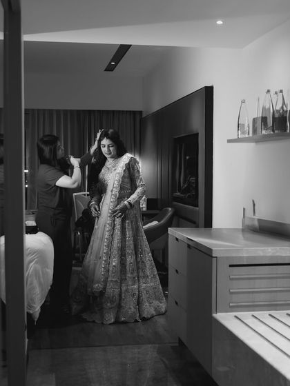 A behind-the-scenes, black and white shot of the bride getting ready for her big moment.