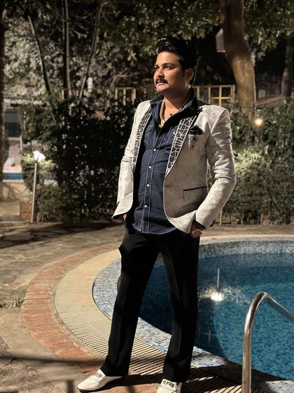 A client by the pool in a light-colored blazer with patterned lapels. This is a great example of a smart-casual piece for an evening social event.