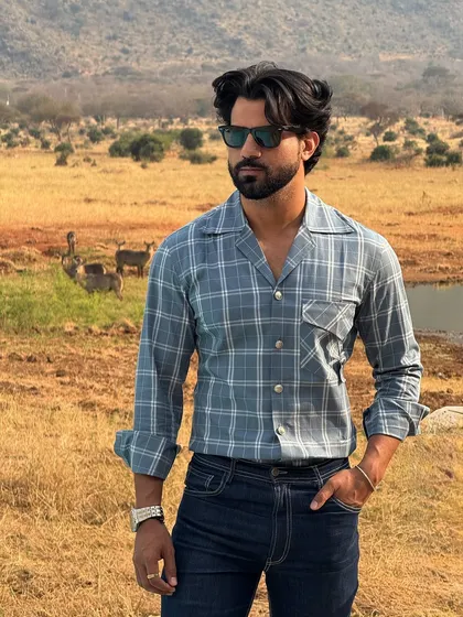Our "Wilderness" shirt in a muted blue check, designed with a relaxed collar. It's the perfect companion for a game drive or a sundowner in the bush.