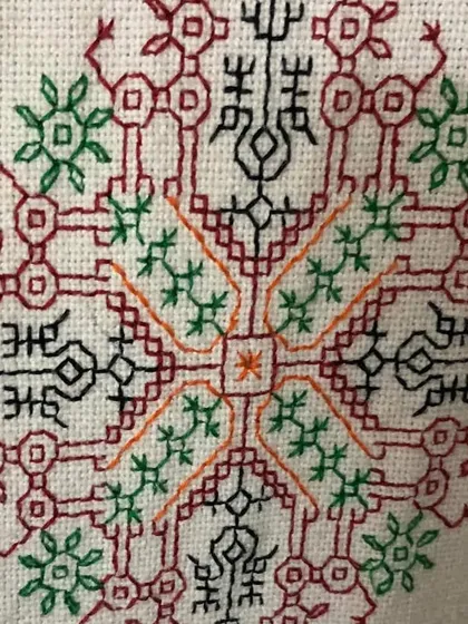 A detailed look at a complex, symmetrical Kasuti motif. Creating such a balanced and intricate design with counted stitches requires a high level of skill and precision.