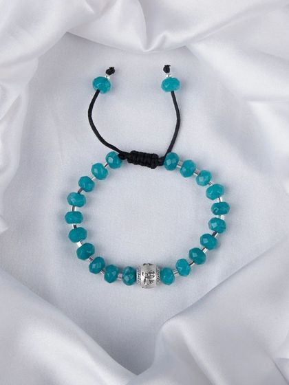 A turquoise-colored beaded bracelet with a central silver bead.