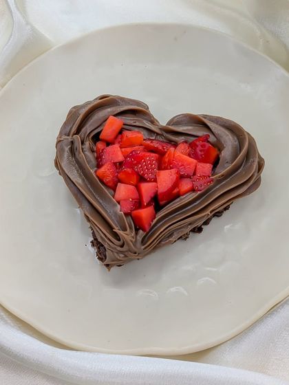 A simple yet elegant heart-shaped chocolate tart filled with freshly chopped strawberries, a perfect little treat for your valentine.