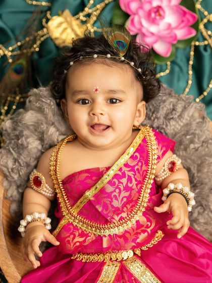 A close-up of a beautiful baby girl dressed as Radha for Janmashtami. Her sweet smile and traditional jewelry are simply divine.