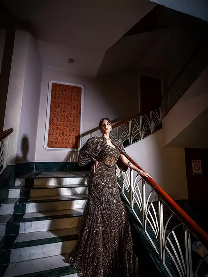 A dramatic shot from our 2025 bridal campaign. This look features a dark, elegant gown and bold makeup, perfect for a grand evening affair.