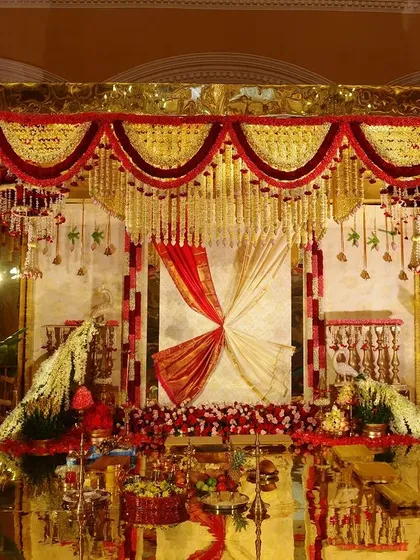Here is a full view of the Royal South Indian decor. The space is filled with vibrant floral arrangements, while the golden mirror floor creates a mesmerizing, kaleidoscopic effect, celebrating both culture and nature.