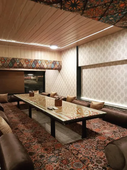 The cozy and intimate ambiance of one of my private Dastarkhwan sections. This setup is ideal for families or groups looking for their own space to enjoy a meal together.