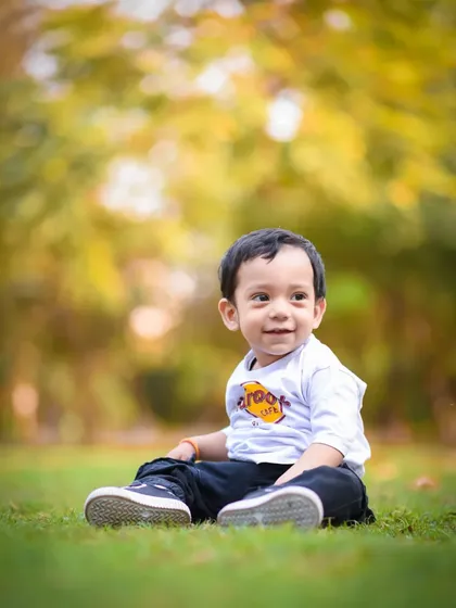 A simple, happy portrait of a little boy enjoying a sunny day in the park. Sometimes the most beautiful photos are the most natural ones.