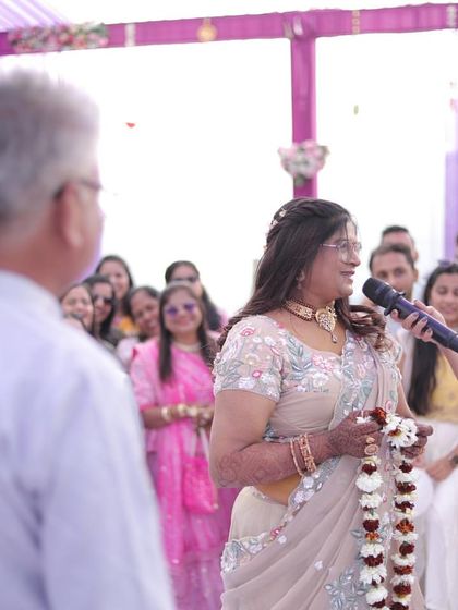 Engaging with the family members during a Varmala game at a daytime event. These personal interactions make the ceremony much more special and memorable for the couple's parents.