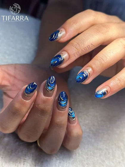 Inspired by the deep ocean, this mesmerizing set features a rich blue cat-eye effect that mimics moving water, framed with elegant silver chrome swirls for a touch of liquid metal luxury.