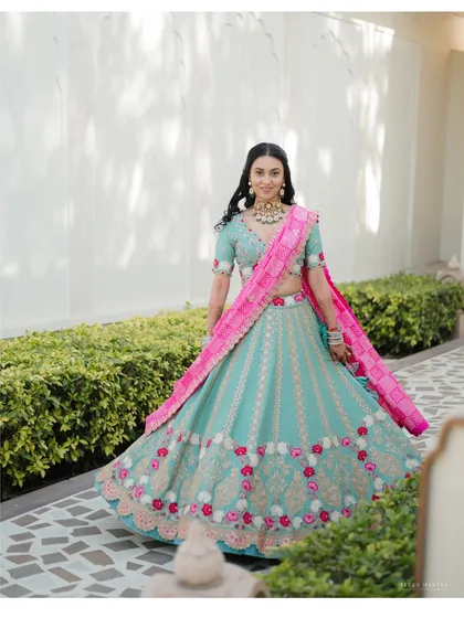 A full-length view of a vibrant Mehendi look. I styled the bride in a beautiful mint green and pink lehenga, perfect for a daytime event. The twirl shot showcases the flow and intricate floral details of the skirt.