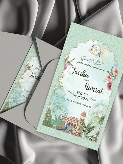 Timeless elegance for your special day. This exquisite static Save the Date card features a beautiful Rajasthani miniature painting style, with peacocks and palaces, enclosed in a sophisticated grey envelope.
