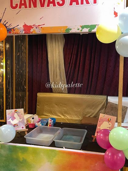 A glimpse of our art party setup with different stations for canvas art and crayon making. Offering a variety of activities keeps all the kids engaged.