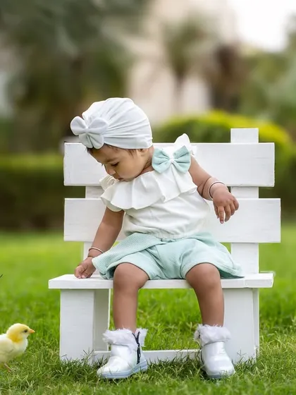 A moment of gentle curiosity as this birthday girl meets a tiny chick. Outdoor shoots allow for these sweet, unscripted interactions.