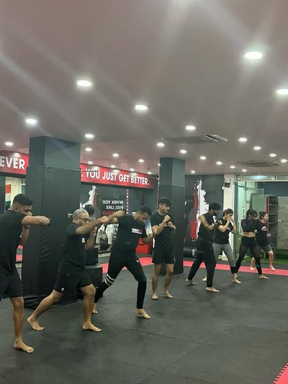 Students line up to begin their session with a senior sensei, showing respect and readiness to learn.