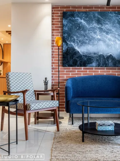 From one of our earliest projects, this living room shows our love for bold color. An exposed brick wall is paired with a deep blue sofa and a striking piece of art, creating an expressive and personal space.
