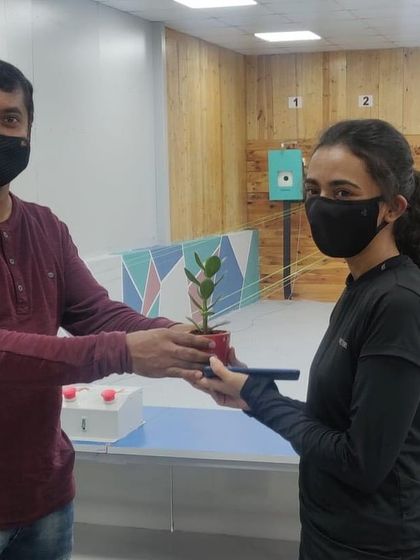A participant receiving a plant as a token of appreciation during our October talent test match.