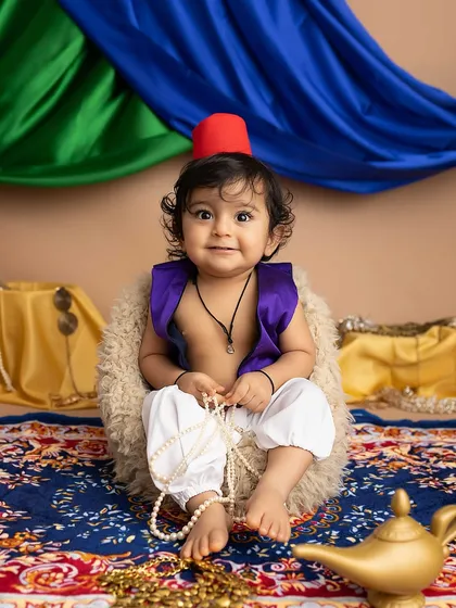 This little Aladdin is the naughtiest, cutest thief of hearts! Playing with pearls from his treasure.