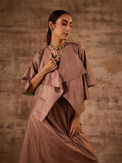 This look from a recent festive campaign showcases modern layering with Indian wear. I paired a draped, layered jacket with a matching set, accessorized with a statement polki necklace to add a touch of traditional grandeur.