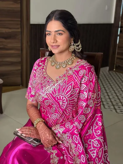 A seated portrait showing the delicate details of her makeup. The look is classic, elegant, and perfect for her traditional outfit.