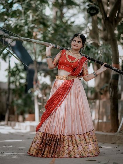 For the Makara Sankranthi festival, I designed this exquisite Zari Kota lehenga for my client. The peach skirt with a traditional border is paired with a red brocade blouse, creating a vision of grace and tradition.
