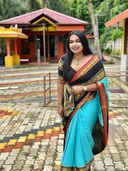 Another beautiful shot of the client at a temple, looking radiant in her Dhavala saree.