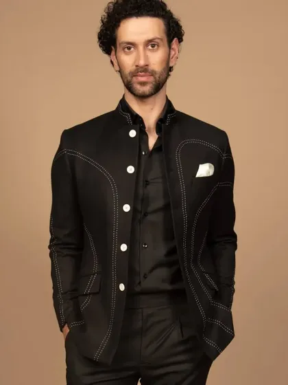 A confident pose in the black contrast-stitched Bandhgala. This piece is a fusion of tradition and modernity, perfect for the man who appreciates unique details.
