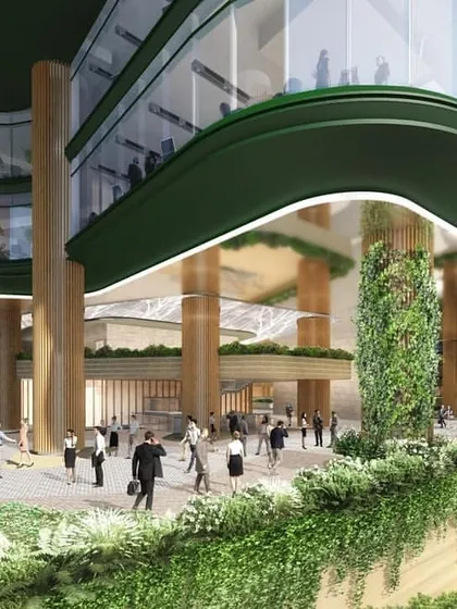 The ground-level view of the NESCO project, illustrating how the building's entrance is designed to be a bustling public space. The use of natural materials like wood and extensive vertical gardens blurs the line between indoors and outdoors.