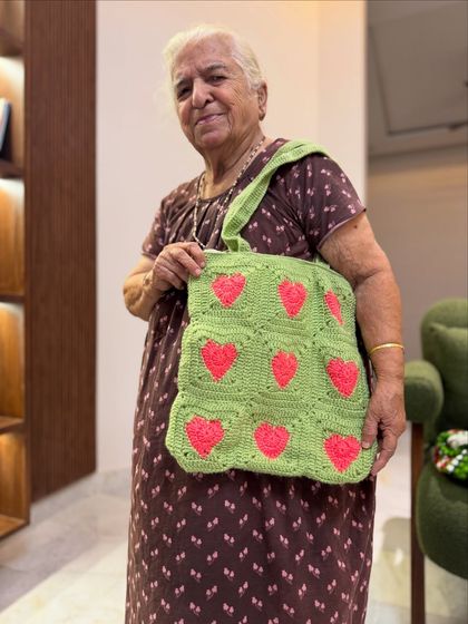This lime green tote with bright pink hearts is for those who love a bold and playful look. It’s such a fun and eye-catching piece.